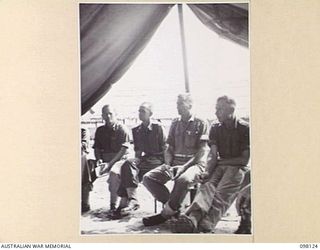 CAPE WOM, NEW GUINEA. 1945-10-20. CORPS OF AUSTRALIAN ELECTRICAL AND MECHANICAL ENGINEERS OFFICERS ATTENDING THE WEEKLY CONFERENCE AT HEADQUARTERS 6 DIVISION. AT THIS CONFERENCE WORK IS REVIEWED, ..