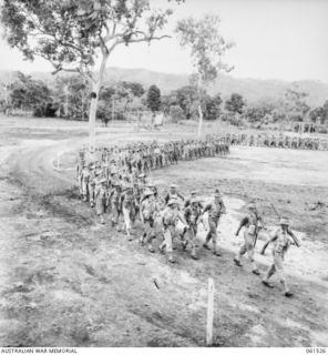 POM POM VALLEY, NEW GUINEA. 1943-11-30. 2/12TH AUSTRALIAN INFANTRY BATTALION, MARCHING OFF THE SHOWGROUND AFTER AN INSPECTION BY THEIR COMMANDING OFFICER, QX6008 LIEUTENANT COLONEL C. C. BOURNE. ..