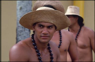 Young men wearing straw hats and necklaces