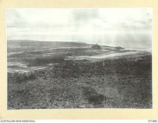 LAE, NEW GUINEA. 1944-03-30. LAE AIRFIELD VIEWED FROM THE AIR WITH THE TOWNSHIP AND THE SEA IN THE BACKGROUND