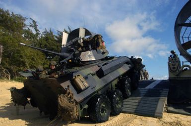 A US Marine Corps (USMC) Amphibious Assault Vehicle (AAV) from the USMC 4th Light Armored Reconnaissance (LAR), Charlie Company (C CO) disembark from a US Navy (USN) Landing Craft Air-Cushion (LCAC) craft after landing at a beach at Bellows Air Force Station (AFS), Hawaii (HI), during an amphibious assault training during Exercise Rim of the Pacific (RIMPAC) 2006. The exercise designed to increase the tactical proficiency of participating units in a wide array of combined sea operations. RIMPAC 2006 brings together military forces from Australia (AUS), Canada (CAN), Chile (CHL), Peru (PER), Japan (JPN), the Republic of Korea (KOR), United Kingdom (UK) and the United States (US)