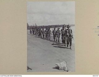 WEWAK AREA, NEW GUINEA. 1945-05-13. TROOPS OF 2/8 INFANTRY BATTALION MARCHING ALONG THE BEACH NEAR WEWAK ON THEIR WAY TO RELIEVE THE 2/4 INFANTRY BATTALION. IDENTIFIED PERSONNEL ARE:- CORPORAL W.A. ..