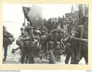 TSIMBA AREA, BOUGAINVILLE ISLAND. 1945-02-21. MEMBERS OF HEADQUARTERS COMPANY, 26TH INFANTRY BATTALION COMING ASHORE IN LANDING BARGES AT PUTO BEACH TO RELIEVE MEMBERS OF THE 31/51ST INFANTRY ..