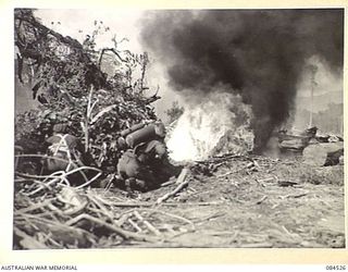 BOUGAINVILLE, SOLOMON ISLANDS. 1944-12-21. UNITED STATES M1A1 FLAME THROWERS OPERATED BY AUSTRALIAN TROOPS AT HEADQUARTERS 3 DIVISION, FIRING ON PILLBOXES DURING A PLATOON ATTACK DEMONSTRATION