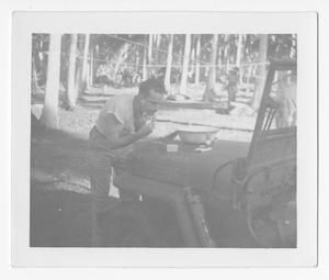 [Serviceman Shaving with Shaving Equipment on Jeep Hood]