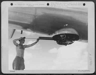 After The First Bombing Mission Over Tokyo, Japan, A Gunner On One Of The Boeing B-29 "Superfortresses"', Which Participated In The Raid, Cleans His Guns. Saipan, Marianas Islands, November 1944. (U.S. Air Force Number A64284AC)