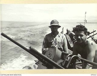 YAGOMAI, NEW GUINEA, 1944-02-10. PRIVATE NEIL WAHLMAN (1) OF MAINE, PICTURED WITH SERGEANT JOHN D. WHORTON (2) OF GEORGIA, MANNING THE TWIN 50 CALIBRE GUNS. BOTH ARE MEMBERS OF THE UNITED STATES ..