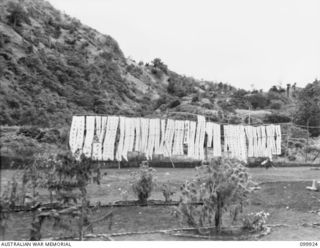 RABAUL, NEW BRITAIN, 1946-03-16. CHINESE BANNERS DISPLAYED NEAR THE MONUMENT AND SHRINE ERECTED TO CHINESE WAR DEAD. OF THE 653 CHINESE WHO DIED WHILST CAPTIVES OF THE JAPANESE 259 WERE RE-INTERRED ..