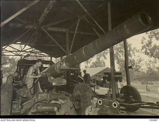 Port Moresby, New Guinea. 1944-05-30. Members of the Moresby Fortress Workshop overhauling a 155mm M1917 field gun in the unit workroom. Identified personnel: Corporal (Cpl) S. J. Farrell (1); ..