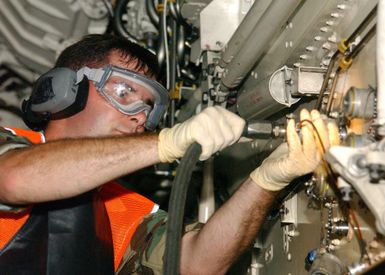 US Air Force (USAF) SENIOR AIRMAN (SRA) Mike Hull, a Crew CHIEF assigned to the 509th Aircraft Maintenance Squadron (AMXS) performs a maintenance check on a USAF B-2 Spirit aircraft, while deployed at Andersen Air Force Base (AFB), Guam (GU), during Exercise CORONET BUGLE 49