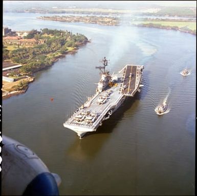 An Aerial Port Bow View of the Anti-Submarine Warfare Support Aircraft Carrier, USS Hornet, as It Enters the Harbor After the Apollo 11 Recovery