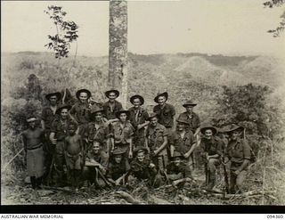 Ulunkohoitu, New Guinea. 1945-07-18. Group photograph of members of 7 Platoon, A Company, 2/6th Australian Infantry Battalion, AIF, including their cooks and two native water boys