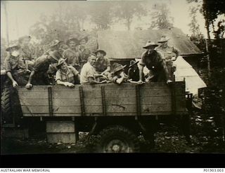Lae, New Guinea. 1944. Men in the back of a truck at the camp at Butibum Road, Lae, of 2 Field Survey Company, No 1 Section, Detached. Left to right: unknown, Jack Fenton, Harry Jackson, Jeff ..