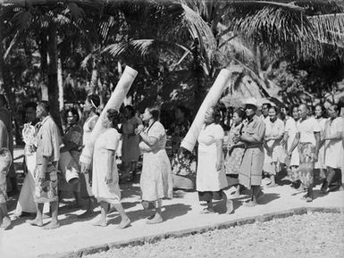 [Men and woman proceeding along a pathway]