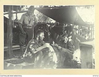 KARKAR ISLAND, NEW GUINEA. 1944-06-02. TROOPS RESTING IN A DAMAGED MISSION WHICH HAS RECENTLY BEEN CAPTURED BY MEMBERS OF THE 37/52ND INFANTRY BATTALION. IDENTIFIED PERSONNEL ARE: SERGEANT RAFTY, ..