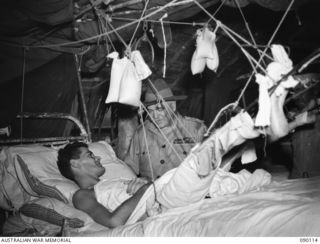 AITAPE, NEW GUINEA. 1945-03-20. GENERAL SIR THOMAS A. BLAMEY, COMMANDER-IN-CHIEF, ALLIED LAND FORCES, SOUTH WEST PACIFIC AREA (RIGHT), TALKING TO PRIVATE H.J. MURPHY, 2/1 INFANTRY BATTALION (LEFT), ..