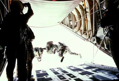 Three members of the combat control team, bail out of their aircraft during high-altitude, low opening (HALO) training