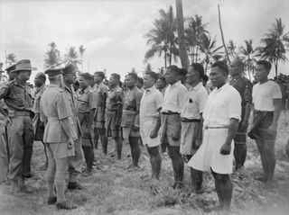NAURU ISLAND. 1945-09-14. BRIGADIER J. R. STEVENSON DSO, COMMANDING 11TH AUSTRALIAN INFANTRY BRIGADE INSPECTING PERSONNEL OF THE GILBERT AND ELLIS ISLAND ARMED NATIVE CONSTABULARY DURING THE ..