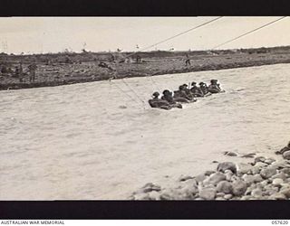 UMI RIVER, NEW GUINEA. 1943-09-29. TROOPS OF THE 2/27TH AUSTRALIAN INFANTRY BATTALION, CROSSING THE RIVER IN RUBBER BOATS