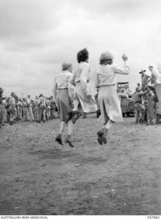 SOPUTA, NEW GUINEA. 1943-10-09. EXCITED UNITED STATES ARMY NURSES JUMP IN THE AIR AS THEIR HORSE PASSES THE POST AT THE RACE MEETING CONDUCTED BY THE 11TH AUSTRALIAN DIVISION