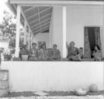 Group sitting on house porch