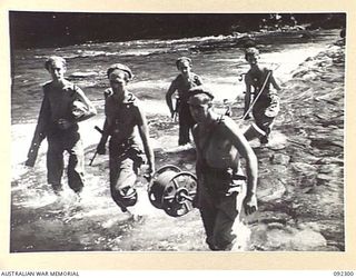 SIGNALLERS OF 15 INFANTRY BRIGADE LAYING CABLE ACROSS THE FORD AT DURHAMS CROSSING TO TACTICAL HQ 57/60 INFANTRY BATTALION, DURING THE DRIVE ALONG THE AXIS OF THE COMMANDO ROAD SOUTH OF THE ..