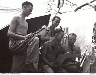 POMPOM VALLEY, NEW GUINEA. 1943-10-26. MUSICIANS OF THE 7TH AUSTRALIAN DIVISION CONCERT PARTY REHEARSING FOR THEIR NEW PRESENTATION. LEFT TO RIGHT:- VX81251 PRIVATE (PTE) T. R. CLEMENS; QX11740 PTE ..