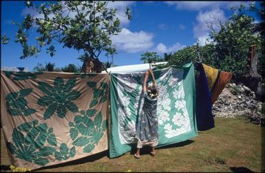 Mama Marenga Tarepo hanging tivaevae on a line