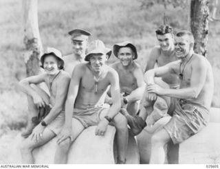 PORT MORESBY, PAPUA. 1942-07. THESE SUN TANNED AUSTRALIAN SOLDIERS IN NEW GUINEA FIND THAT ONLY A MINIMUM OF CLOTHING IS NECESSARY IN THE TROPICAL HEAT. SHIRTS ARE RARELY WORN BY THE TROOPS AND AN ..