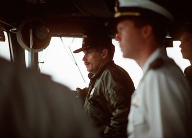 The commanding officer of the amphibious assault ship USS GUAM (LPH-9), center, watches from the bridge as the ship nears Naval Station, Norfolk, Va. The GUAM is returning to Norfolk, following its deployment to the Persian Gulf region for Operation Desert Shield and Operation Desert Storm