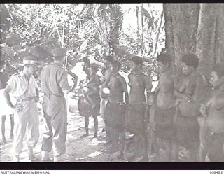 KOIL ISLAND, NEW GUINEA, 1945-10-31. A VISIT TO KOIL ISLAND WAS ARRANGED BY THE RED CROSS FOR THE PURPOSE OF MEDICAL INSPECTION OF THE NATIVE INHABITANTS. THE VISITING PARTY CONSISTED OF AN ..