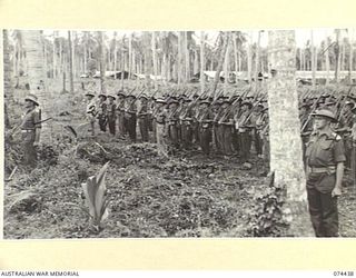 MADANG, NEW GUINEA. 1944-07-01. A JOIN-UP PHOTOGRAPH OF A MORNING PARADE OF THE 24TH INFANTRY BATTALION. TO JOIN TO PHOTOGRAPHS NO. 74439, 74440 AND 74441. IDENTIFIED PERSONNEL ARE:- VX185 ..