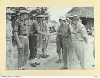 KAKAKOG, NEW GUINEA. 1944-04-25. THE HONOURABLE E.J. WARD, MINISTER FOR EXTERNAL TERRITORIES IN THE AUSTRALIAN GOVERNMENT (1), SHAKES HANDS WITH NGX356 WARRANT OFFICER II, F. PHILLIPS (3), AFTER ..