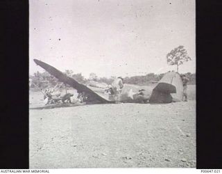MILNE BAY, PAPUA, 1943-01-19. SALVAGING PARTS FROM A P40 KITTYHAWK AIRCRAFT DAMAGED DURING JAPANESE AIR RAID. (DONOR - T.G. JONES)