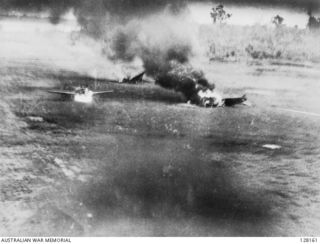 LAE, NEW GUINEA. 1943-03-04. A SURPRISE STRAFING ATTACK BY FLIGHT LIEUTENANT R. F. UREN AND FLYING OFFICER R. H. ROE (RAAF) ON MALAHANG AIRFIELD, IN WHICH SIX JAPANESE ZEROS AND ONE REFUELLING ..