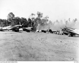 Northern New Guinea. 1944-07-01. RAAF Curtiss P40 Kittyhawk fighter aircraft prepare to take off on a mission to provide cover for bombers attacking the Japanese in Dutch New Guinea