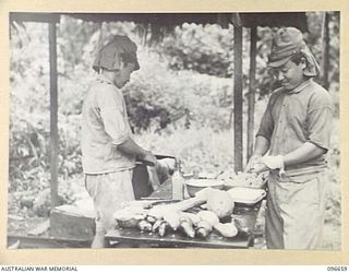 BUKA ISLAND, BOUGAINVILLE AREA. 1945-09-16. JAPANESE NAVAL TROOPS PREPARING A MEAL AT THEIR HEADQUARTERS. FOLLOWING SURRENDER DISCUSSIONS ARRANGEMENTS HAVE BEEN MADE FOR THE CONCENTRATION OF THESE ..