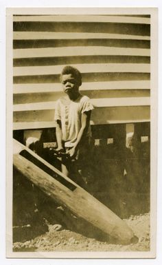 Schoolboy playing on a wooden drum