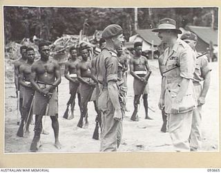 HONGORAI RIVER, BOUGAINVILLE, 1945-07-04. HIS ROYAL HIGHNESS, THE DUKE OF GLOUCESTER, GOVERNOR-GENERAL OF AUSTRALIA (2), SPEAKING WITH LIEUTENANT R.H. CAMPBELL, PAPUAN INFANTRY BATTALION (1), ..