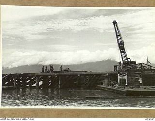 LAE, NEW GUINEA, 1943-11-05. ENGINEERS OF THE 1052ND ENGINEERS PORT CONSTRUCTION AND REPAIR GROUP, UNITED STATES ARMY, WORKING ON THE CONSTRUCTION OF THE FIRST LIBERTY DOCK. SHOWN IS:- ASN-33480320 ..