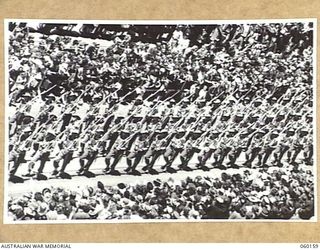 MELBOURNE, AUS. 1943-11-18. TROOPS OF THE 17TH AUSTRALIAN INFANTRY BRIGADE MARCHING ALONG SWANSTON STREET UPON ITS RETURN TO THE MAINLAND AFTER A LONG TERM OF ACTIVE SERVICE IN NEW GUINEA