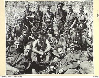 NEW GUINEA. GONA. THESE AUSTRALIANS HAVE JUST COME 100 YARDS BACK FROM THE FRONT LINE FOR FOOD DURING A LULL IN THE FIGHTING THEY ARE PART OF A COMPANY WHICH HAS BEEN 2 DAYS AND NIGHTS WITHIN ..