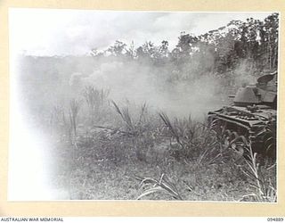 TOROKINA AREA, BOUGAINVILLE. 1945-08-12. AN M24 GENERAL CHAFFEE LIGHT TANK FIRING THREE ROUNDS RAPID AGAINST A BUNKER DURING TRIALS CONDUCTED FOR THE WAR OFFICE. THE FUSE WAS SET AT .05 DELAY