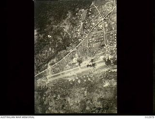 LAE, NEW GUINEA. 1942-08-08. AERIAL PHOTOGRAPH OF THE AIRSTRIP TAKEN DURING A BOMBING ATTACK BY ALLIED FORCES. SMOKE CAN BE SEEN BILLOWING UP FROM THE GROUND