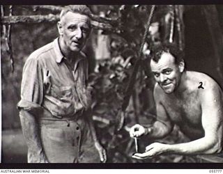 MOROBE, NEW GUINEA. 1943-08-13. MR M. J. GILMORE, SALVAGE MASTER (LEFT) AND MR C. F. MCCLAUSLAND, CHIEF ENGINEER, BOTH OF THE UNITED STATES SMALL SHIPS SECTION