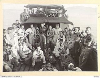 LALUM, BOUGAINVILLE, 1945-06-12. A BARGE LOAD OF WOUNDED MEN, MEMBERS OF 31/51 INFANTRY BATTALION, BEING TRANSPORTED TO THE HOSPITAL SHIP STRADBROKE. THEY WERE MOVED FROM 19 FIELD AMBULANCE MAIN ..
