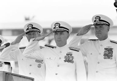 From left to right, CHIEF of Naval Operations ADM Thomas B. Hayward, ADM Sylvester R. Foley Jr., and CHIEF of Naval Operations Designate ADM James D. Watkins salute during the ceremony in which ADM Foley assumes command of the U.S. Pacific Fleet