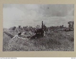 WEWAK AREA, NEW GUINEA. 1945-05-13. THE WRECKAGE OF JAPANESE AIRCRAFT AT THE AIRSTRIP WITHIN 2/4 INFANTRY BATTALION AREA, AMONGST WHICH CAN BE SEEN A "BETTY" MEDIUM BOMBER. IT IS MUTE EVIDENCE OF ..
