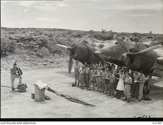 KIRIWINA, TROBRIAND ISLANDS, PAPUA. C. 1944-04. GROUP PORTRAIT TAKEN AT AN EASTER SUNDAY CHURCH SERVICE IN FRONT OF A BEAUFIGHTER AIRCRAFT IN A DISPERSAL BAY FOR SERVICING CREWS OF NO. 30 ..