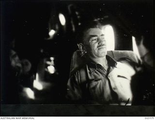 IN FLIGHT BETWEEN HOLLANDIA, DUTCH NEW GUINEA AND AITAPE, NORTH EAST NEW GUINEA. C. 1944-06. JOHN DEDMAN, THE MINISTER FOR WAR ORGANISATION OF INDUSTRY, WHO ACCOMPANIED ARTHUR DRAKEFORD, THE ..